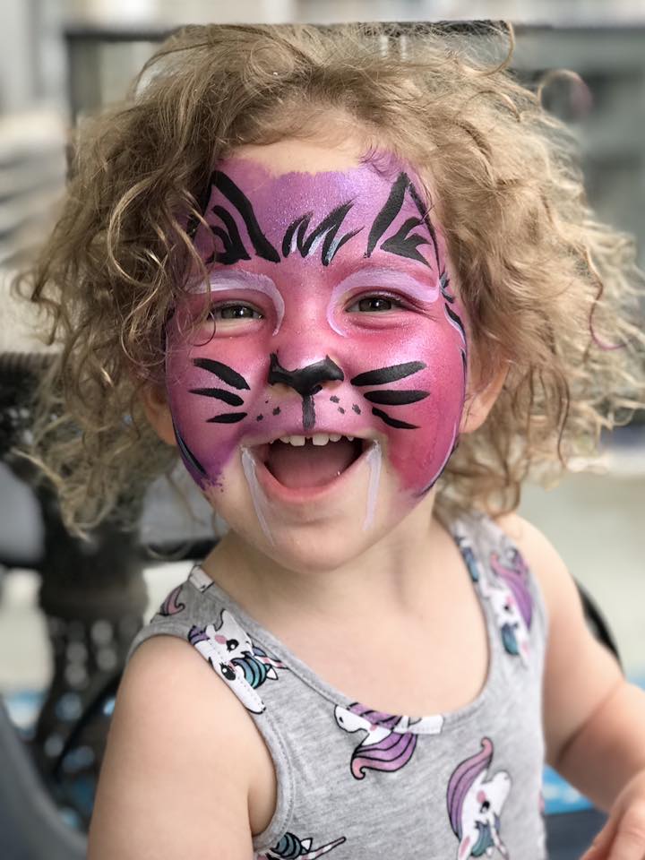 Child with cute cat face painting design