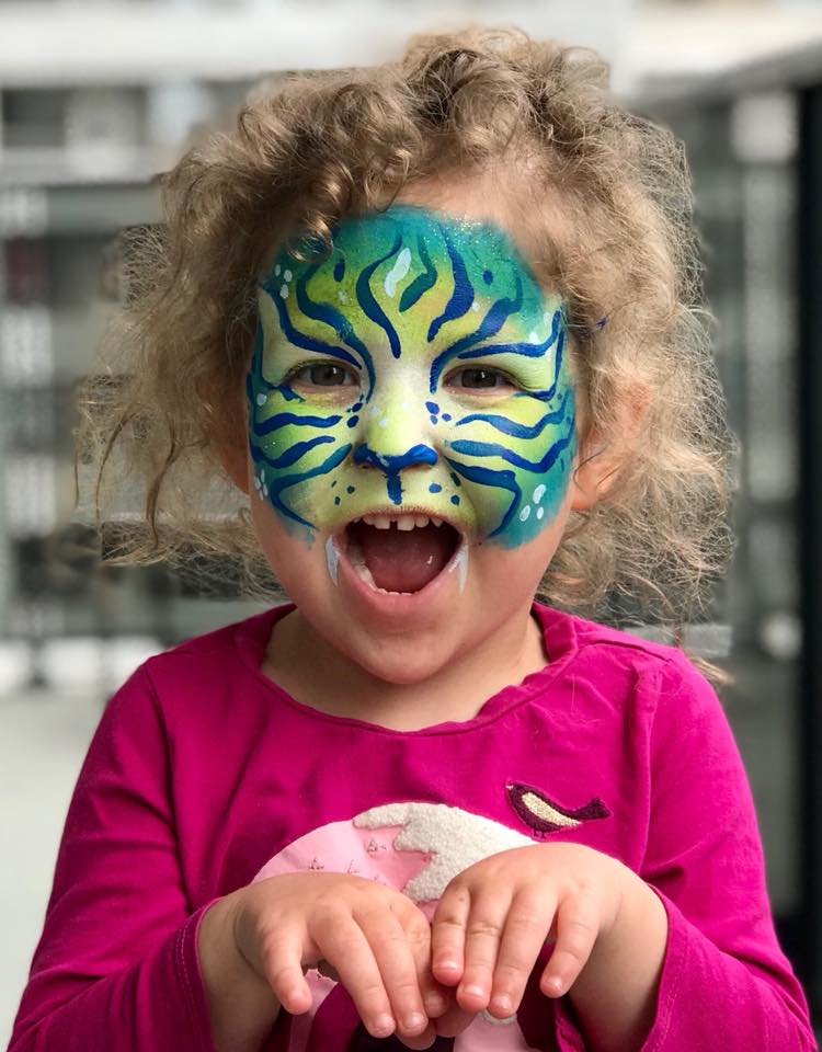 Child with detailed tiger face painting design